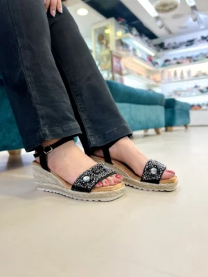 Add a touch of sparkle to your step with the Urbantoes Glimmer Black Studded Wedge Sandals. Designed for women who love style, comfort, and durability, these wedges feature eye-catching stud embellishments that elevate any outfit instantly. The cushioned insole ensures all-day comfort, while the sturdy wedge heel offers stability for effortless wear. Lightweight yet durable, these sandals are perfect for office wear, casual outings, parties, or festive occasions. The classic black color makes them versatile and easy to pair with ethnic, western, or Indo-western attire. Whether you’re dressing up for a special occasion or adding a chic touch to everyday wear, the Glimmer Black Studded Wedges combine elegance, comfort, and practicality for modern women who want their footwear to make a statement.